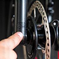 Person inspecting e-bike disk brakes
