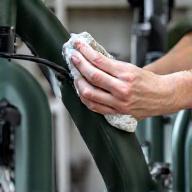Person cleaning an e-bike