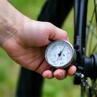 Person checking e-bike tire pressure